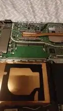 Gently insert the new RAM module into the slot at an angle and pressing it down until the metal clips on the sides click into place.