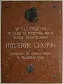 Gedenktafel in der Kirche des Heiligen Rochus und Johannes des Täufers von Brochów, mit dem Schriftzug:In diesem Gotteshauswurde am 23.&nbsp;April 1810Fryderyk Chopin getauftgeboren am 22.&nbsp;Februar 1810in Żelazowa Wola.