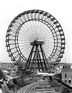Great Wheel (um 1900) ostwärts betrachtet, im Hintergrund ist die Kirche St. Cuthbert’s, Philbeach Gardens zu erkennen