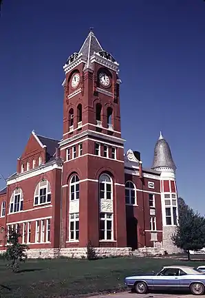 Ehemaliges Haralson County Courthouse (1980). Das Courthouse entstand 1891 und diente in dieser Funktion, bis es durch ein 1972 erbautes Gerichts- und Verwaltungsgebäude abgelöst wurde. Seitdem beherbergt es eine öffentliche Bibliothek und Haralson County Historical Society. Das im Queen-Anne-Stil errichtete Haralson County Courthouse wurde im Juni 1974 als erstes Objekt im County in das NRHP eingetragen.