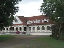 Exterior of a long, white colonial-style building