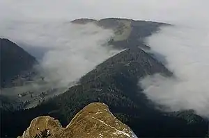 Blick vom Pilatus Richtung Nordwesten über das Klimsenhorn (mit Gipfelkreuz) ins vorwinterliche Eigental bei Hochnebel mit einer Obergrenze um 1000&nbsp;m. Der nordöstliche Ausläufer des Klimsenhorns, die Lauelenegg, setzt sich im bewaldeten Rücken des Höchberg&nbsp;(1198&nbsp;m) fort, danach der Einschnitt Chräigütsch&nbsp;(1081&nbsp;m) und dahinter die umwaldete Matte der Würzenegg&nbsp;(1173&nbsp;m). Am linken Bildrand ist unter dem Ganterseiwald das Gehöft beim Buechstäg&nbsp;(1006&nbsp;m) zu erkennen.