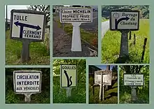Zusammenstellung mehrerer Michelin-Wegweiser mit Standfuß