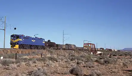 E7008 im blauen Spezialanstrich der SAR für den Einsatz vor dem Blue Train, aber vor einem Güterzug bei Die Put, ungefähr 16&nbsp;km südlich von De Aar, eingesetzt, am 2. Mai 1985