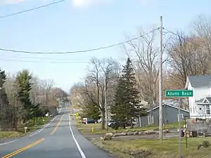 The hamlet of Adams Basin along CR 212.