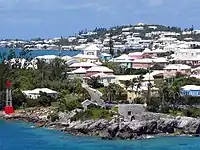Residential suburb near the old St.&nbsp;George's Garrison, with "Town Cut Battery" or "Gate's Fort" on the shore of the Town Cut, and St.&nbsp;George's Town and its harbour in the background
