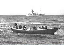 USFS&nbsp;Penguin (background) at anchor in the Bering Sea in 1939 while she unloads off St. George Island in the Pribilof Islands.